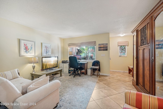 home office featuring light tile patterned floors and a textured ceiling