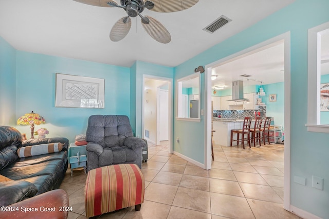 tiled living room with ceiling fan