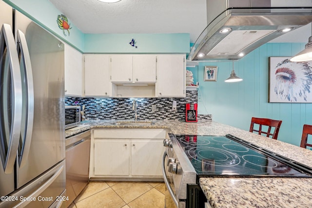 kitchen with decorative backsplash, appliances with stainless steel finishes, sink, light tile patterned floors, and pendant lighting