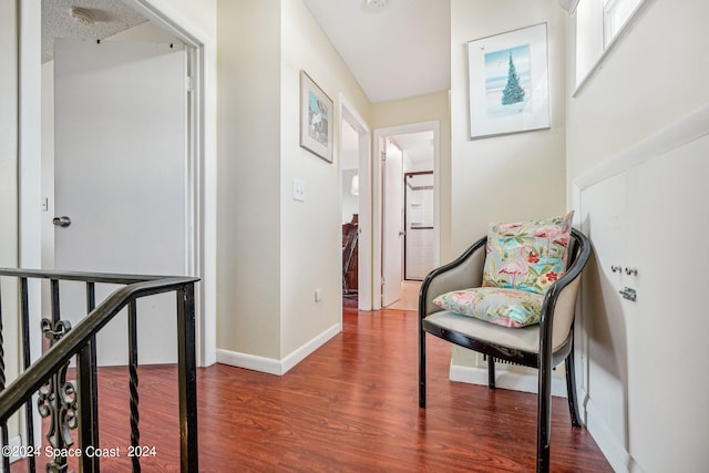 sitting room with dark wood-type flooring