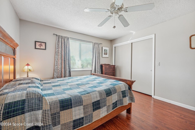 bedroom featuring wood-type flooring, a textured ceiling, a closet, and ceiling fan