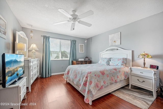 bedroom featuring a textured ceiling, ceiling fan, and dark hardwood / wood-style floors