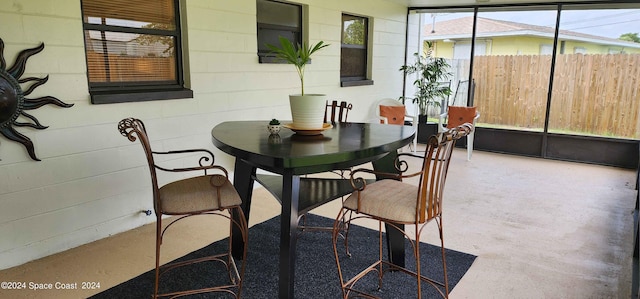 dining room featuring a healthy amount of sunlight and concrete floors