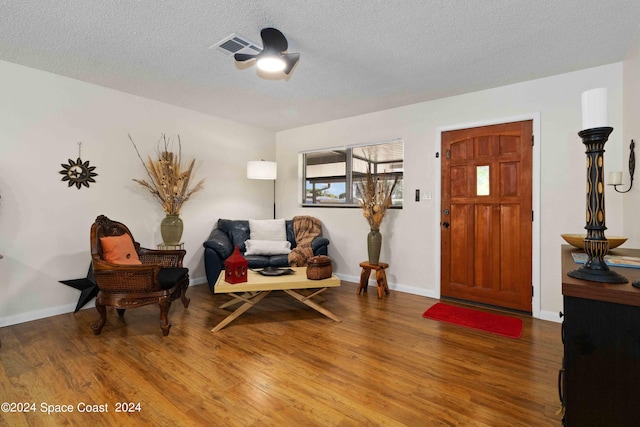 foyer entrance featuring hardwood / wood-style floors and a textured ceiling