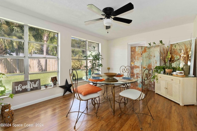 dining area with hardwood / wood-style flooring and ceiling fan