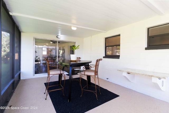 dining area featuring beam ceiling