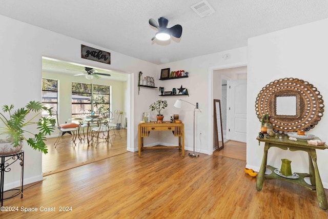 interior space with a textured ceiling and light wood-type flooring