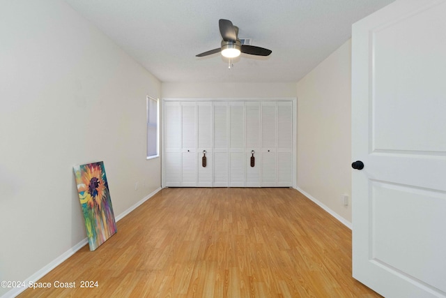 unfurnished bedroom with a closet, ceiling fan, and light hardwood / wood-style flooring