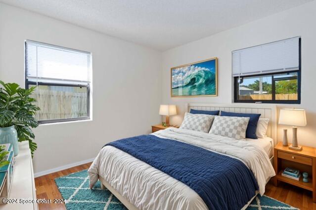 bedroom with hardwood / wood-style flooring