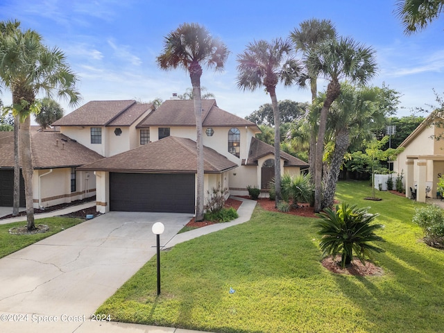 front of property featuring a front lawn and a garage