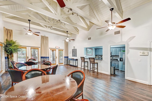 dining space with beamed ceiling, high vaulted ceiling, and dark hardwood / wood-style flooring