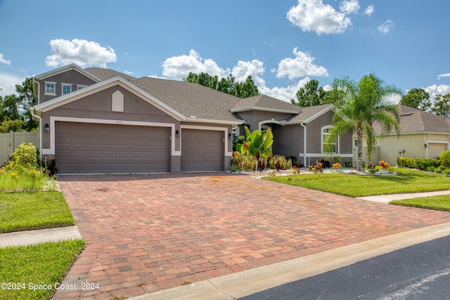 view of front of property with a garage and a front lawn