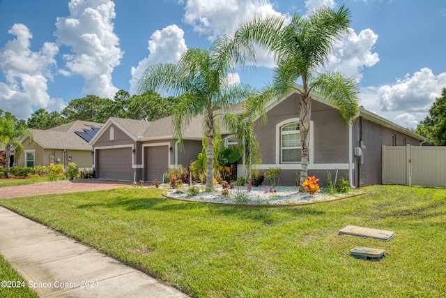 ranch-style house with a garage and a front yard