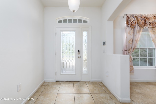 foyer entrance with light tile patterned flooring