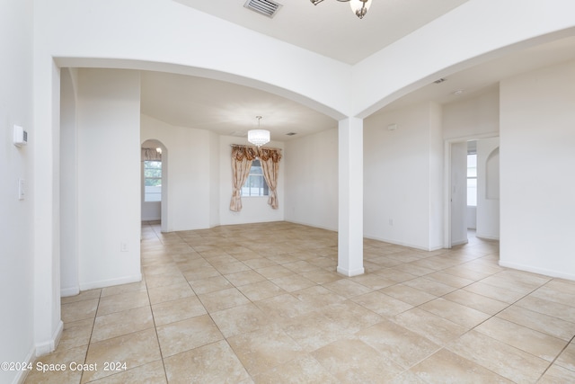 spare room with light tile patterned flooring and a wealth of natural light