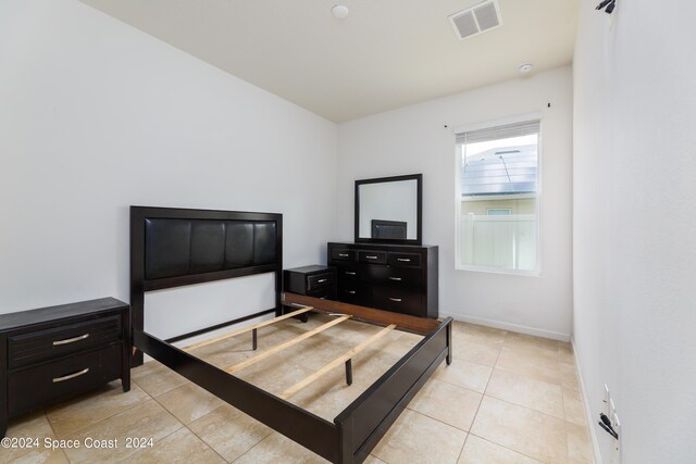 bedroom with light tile patterned flooring