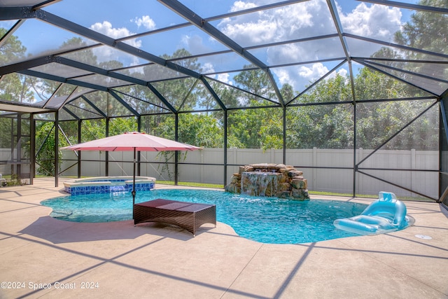 view of swimming pool featuring a patio, an in ground hot tub, a lanai, and pool water feature