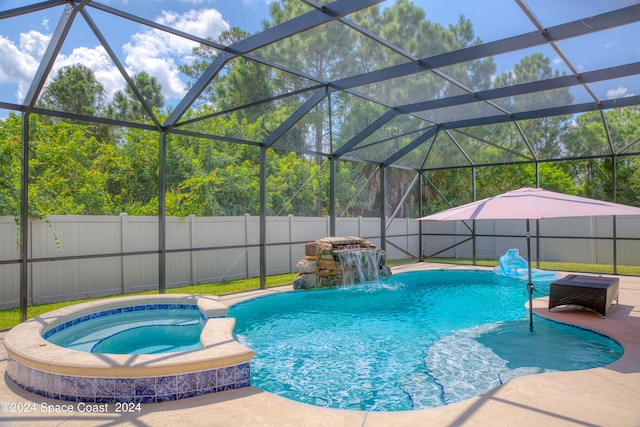 view of swimming pool featuring a lanai, pool water feature, an in ground hot tub, and a patio