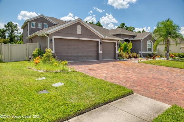 view of front of house with a front yard and a garage