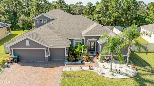 view of front of property with a garage and a front lawn