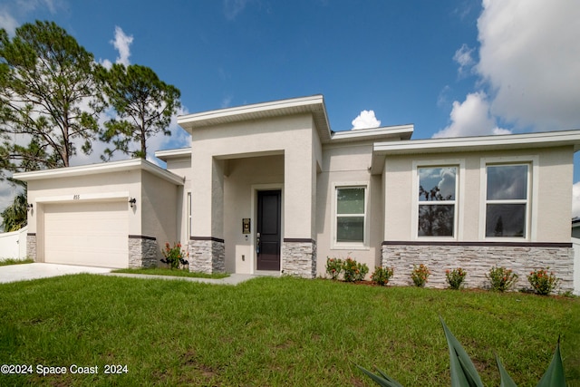 view of front of house with a front yard and a garage