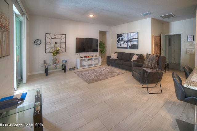 living room with a textured ceiling