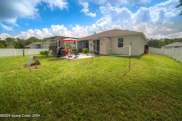 back of house featuring a yard and a patio area