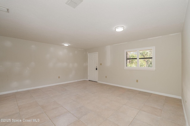 spare room with a textured ceiling