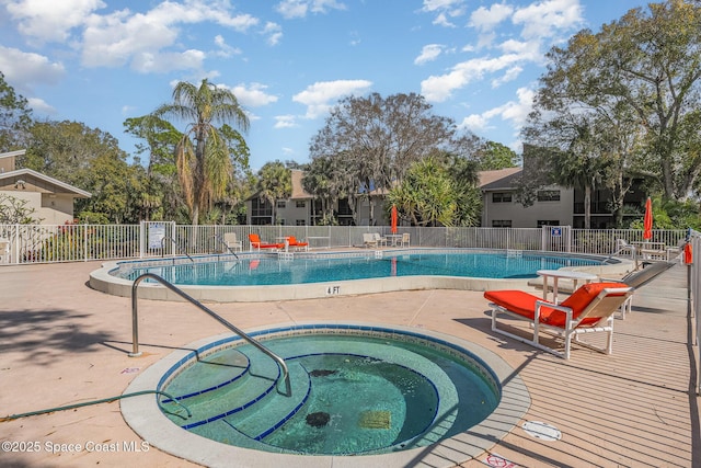 view of pool featuring a hot tub and a patio area