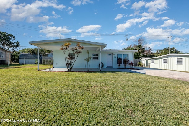 view of front of house with a carport, a front yard, and a porch