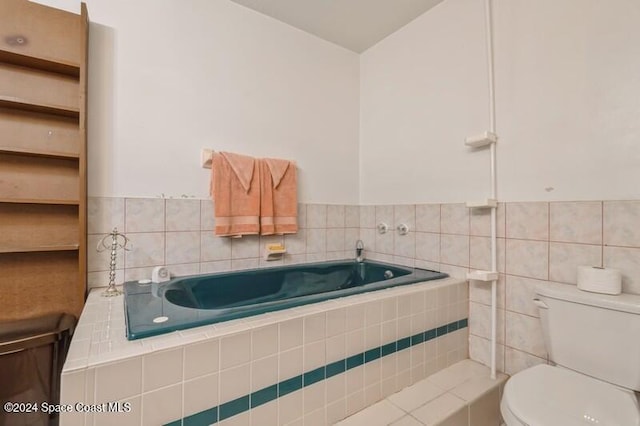 bathroom with a relaxing tiled tub and toilet