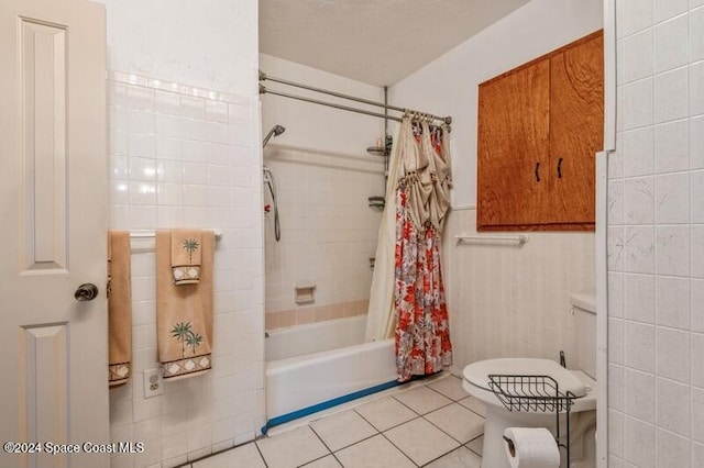 bathroom featuring toilet, tile patterned floors, and shower / bath combo with shower curtain