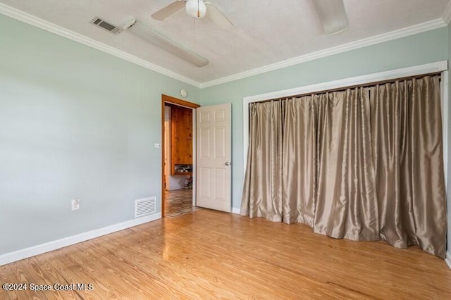 unfurnished bedroom featuring crown molding, wood-type flooring, and ceiling fan