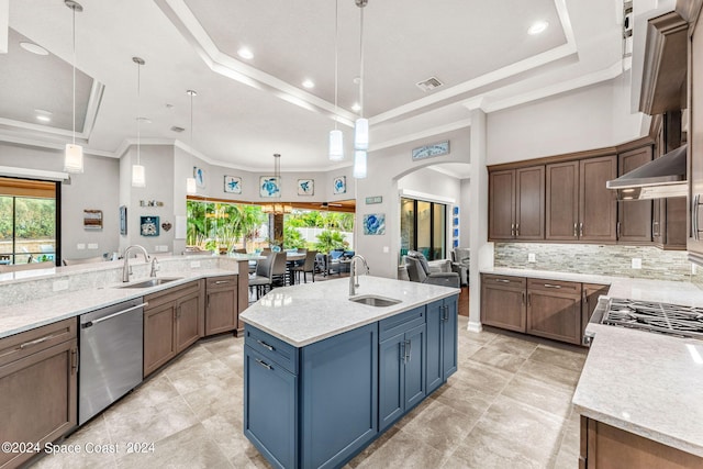 kitchen with hanging light fixtures, a spacious island, stainless steel dishwasher, and sink