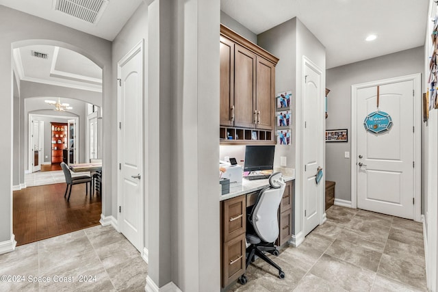 office space featuring built in desk and an inviting chandelier