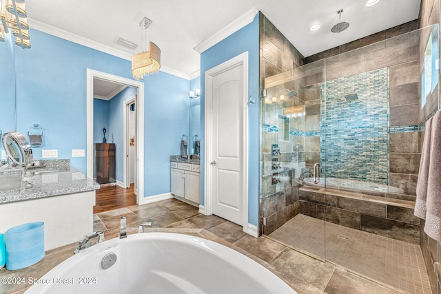 bathroom with vanity, ornamental molding, and shower with separate bathtub