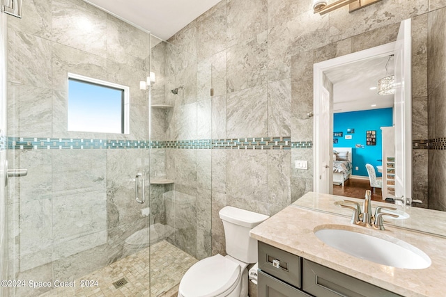 bathroom with an enclosed shower, vanity, and toilet