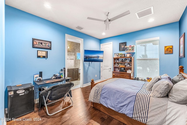 bedroom featuring hardwood / wood-style flooring, ceiling fan, and connected bathroom