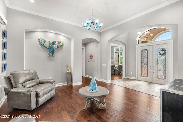 foyer featuring french doors, hardwood / wood-style flooring, and a notable chandelier