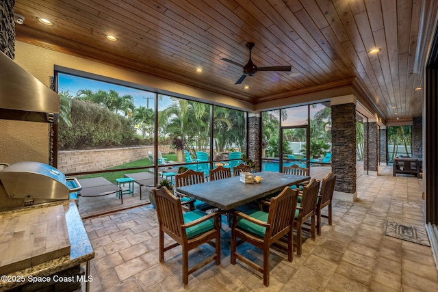 sunroom / solarium featuring ceiling fan and wood ceiling