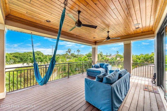 wooden deck with ceiling fan and an outdoor hangout area