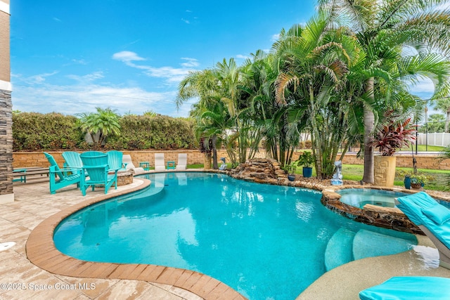 view of swimming pool with an in ground hot tub and a patio