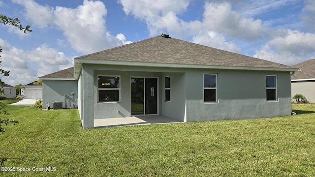 4346 Kelsey Ln, Sebastian, FL 32976 - back of property with a shingled roof, stucco siding, a lawn, and a patio area
