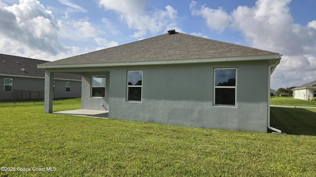 4346 Kelsey Ln, Sebastian, FL 32976 - back of property featuring a shingled roof, stucco siding, and a patio area