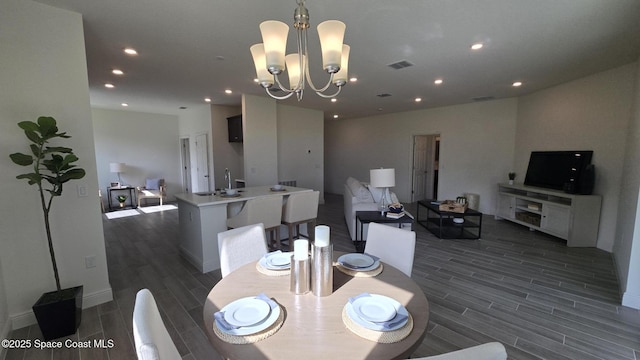 4346 Kelsey Ln, Sebastian, FL 32976 - dining space with wood finish floors, a chandelier, and recessed lighting