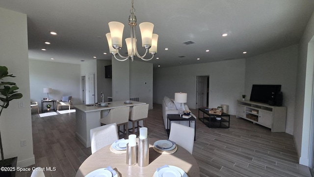4346 Kelsey Ln, Sebastian, FL 32976 - dining room with dark wood finished floors, a chandelier, and recessed lighting
