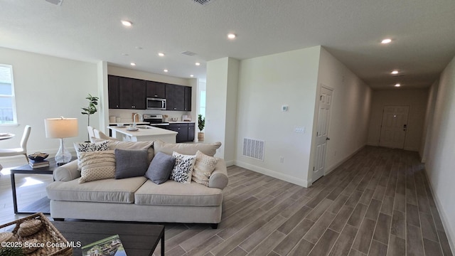 4346 Kelsey Ln, Sebastian, FL 32976 - living area with wood finished floors and recessed lighting