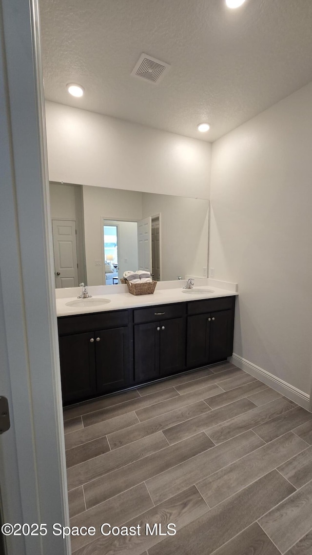 4346 Kelsey Ln, Sebastian, FL 32976 - bathroom with wood finish floors, double vanity, and recessed lighting