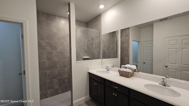4346 Kelsey Ln, Sebastian, FL 32976 - bathroom with walk in shower, double vanity, a textured ceiling, and recessed lighting