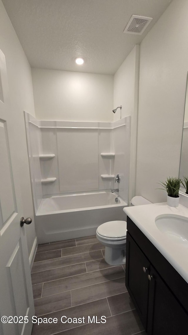 4346 Kelsey Ln, Sebastian, FL 32976 - bathroom with vanity, bathing tub / shower combination, recessed lighting, wood tiled floors, and a textured ceiling